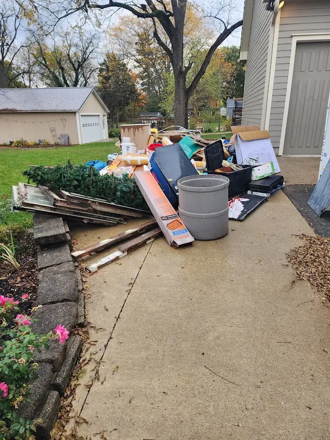 Dumpster being loaded with debris for Roofing Dumpster Rental in Thompson